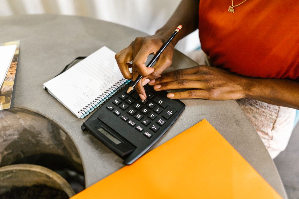 Landlord reviewing rental income and expenses with a calculator