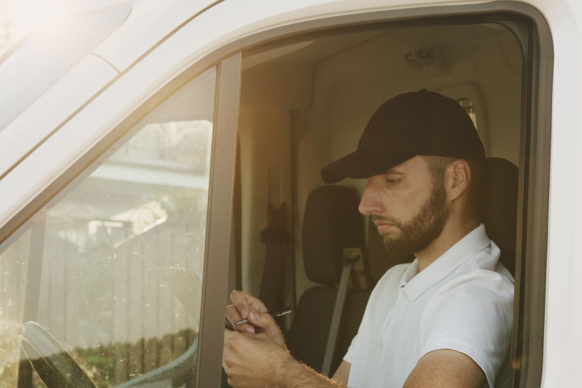 Tradesperson checking a schedule on a tablet
